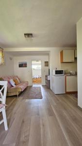 a large room with a kitchen and a living room at Apartmán Karovi in Deštné v Orlických horách