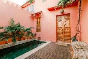 a house with a swimming pool in front of a house at La Marrocco Villas in Nusa Penida