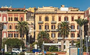 a large building with palm trees in front of it at Centro Storico in Cagliari