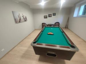 a ping pong table in a room with a pool at Willa Jasiu in Władysławowo