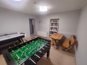 a room with a ping pong table in the middle of a room at Willa Jasiu in Władysławowo