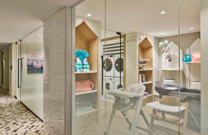 a dressing room with a glass wall and a stool at Grand Josun Busan in Busan