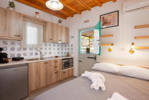 a kitchen with white towels on the floor in a room at Green Bay Studio 1 in Sifnos