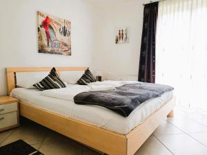 a bedroom with a large bed with white sheets at Residenz Strandkrone 02 in Kühlungsborn