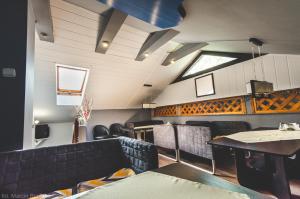 a dining room with black chairs and a table at O.W. Blue Cafe in Krościenko