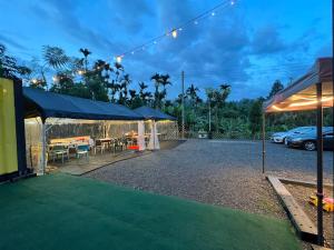 a patio with a table and chairs under a tent at Tea King B&B in Yuchi