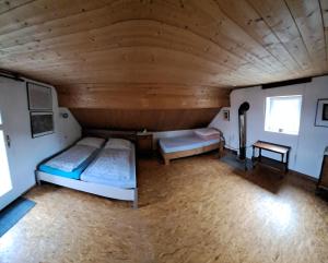 a large room with two beds and a table at Chalupa na Maňavě in Maňava