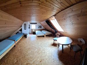 a room with beds and a table in a attic at Chalupa na Maňavě in Maňava