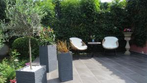 a patio with two chairs and a table with plants at Ferienwohnung Dörner in Pirna