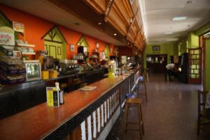 a bar in a restaurant with a person sitting at the counter at Hostal Hermanos Gutierrez in Monasterio de Rodilla
