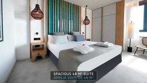 a bedroom with two beds with towels on them at HOVIMA Suites Costa Adeje in Adeje
