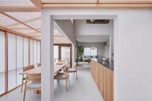 a dining room and kitchen with a table and chairs at SANU 2nd Home SAZARENO 下田 in Shimoda