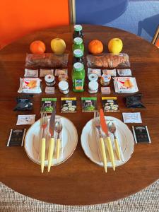 a table with plates of food and utensils on it at La Giovanna Guest Room in Madonna della Scala +2 photos
