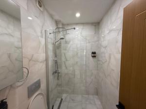 a bathroom with a shower with a glass door at Koçyiğit Suite & Hotel in Istanbul +57 photos