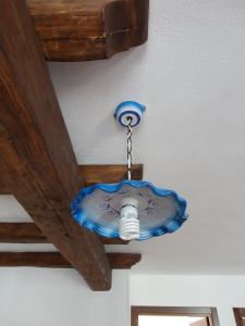 a blue and white ceiling fan hanging from a wall at Bed and Breakfast Ichnos in Cala Gonone