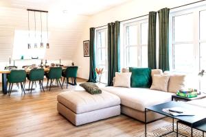 a living room with a couch and a dining room at Rheinsteig Chalét Bendorf in Bendorf