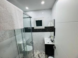 a bathroom with a shower and a sink at Aladín House Vinaròs playa in Vinaròs
