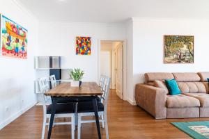 a living room with a table and a couch at GuestReady - Caniço city view in Caniço +23 photos