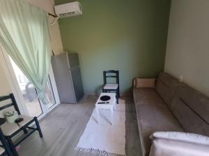 a living room with a couch and a table at Pool me up 22 apartment in Megali Ammos