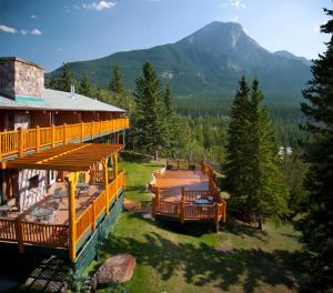 a large building with a mountain in the background at Overlander Mountain Lodge in Jasper