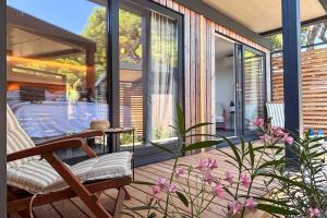 a screened in porch with a chair and a table at Waterman Beach Village in Supetar