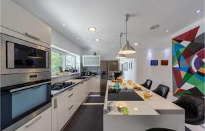 a kitchen with a dining table and a large appliance at Amazing Home In Crikvenica in Crikvenica