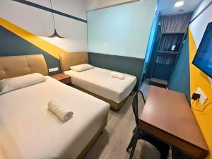 Postel nebo postele na pokoji v ubytování Smile Hotel Subang Airport + 11 fotografií