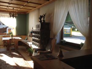 a living room with a table and chairs and a window at Hotel Aquamarin in Bad Mitterndorf
