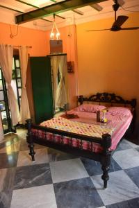 a bedroom with a bed in a room at Bhubanbari in Kolkata