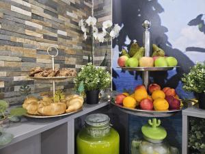a buffet with two plates of fruit and bread at Casa Coral Mamaia Nord in Mamaia Nord +44 photos