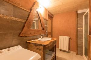 a bathroom with a sink and a toilet at La Petite Serenne - Vue Montagne 