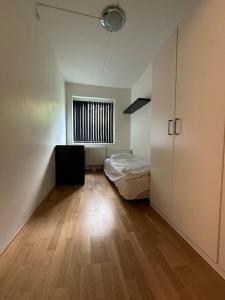 a small bedroom with a bed and a window at Modern & cozy 4BR apartment in Oslo in Oslo