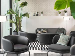 a living room with chairs and a couch at ibis Brussels Centre Chatelain in Brussels