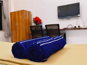 a blue blanket sitting on top of a table at Dolphin Bay Resort in Alibaug