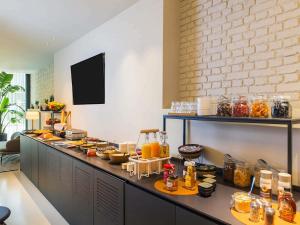 a buffet line with a lot of food on it at ibis Brussels Centre Chatelain in Brussels