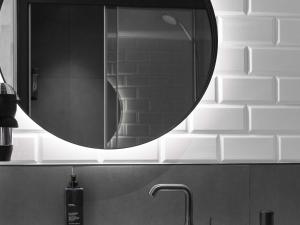 a bathroom sink with a mirror above a sink at ibis Brussels Centre Chatelain in Brussels
