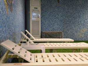 two white chairs sitting in front of a building at Taj Celine Hotel in Jeddah