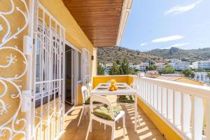 a balcony with a table and chairs and a view at Milenial Immo Almadrava Roses Beach House in Roses