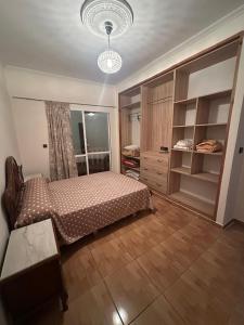 a bedroom with a bed and a chandelier at Diki Beach Cosy place in Hammidane