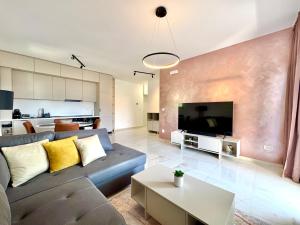 a living room with a couch and a tv at Apartment BAR M3A sea view in Bar