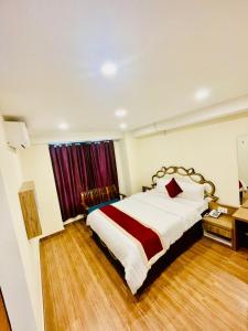 Postel nebo postele na pokoji v ubytování pashupati front hotel