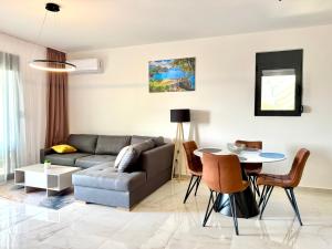 a living room with a couch and a table at Apartment BAR M3A sea view in Bar