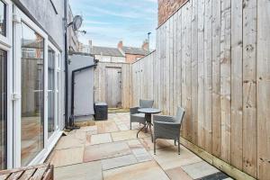 a patio with chairs and a table on a building at Host & Stay - Surf Jewel in Saltburn-by-the-Sea