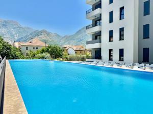 a swimming pool in a building with mountains in the background at Apartment BAR M3A sea view in Bar