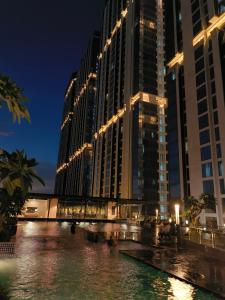 a large building with lights in front of a river at Pollux Habibie Batam Polux in Batam Center
