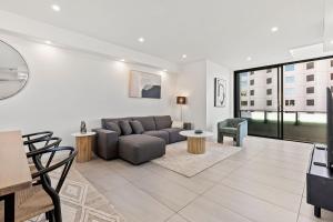 a living room with a couch and a table at Big Two-Story with Private Elevator & Balconies in Sydney