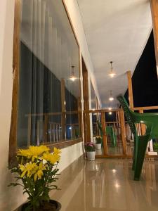 a lobby with a green chair and yellow flowers at Wildscape kaziranga in Kāziranga +21 photos