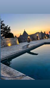 a pool of water in front of a building at Bed & breakfast vecchia vallata in Gioia del Colle