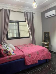 a bedroom with a bed with a red blanket and a window at Maison Royale in Kofa +14 photos