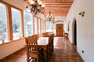a dining room with a table and chairs and windows at Shady Brook Inn Village/Resort in Shady Brook